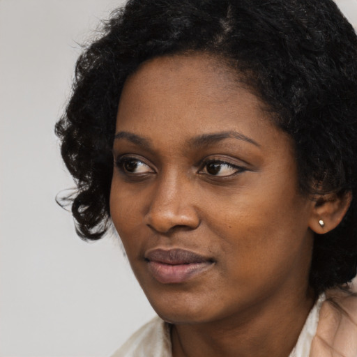 Neutral black young-adult female with medium  black hair and brown eyes