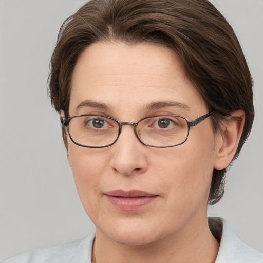 Joyful white adult female with short  brown hair and grey eyes