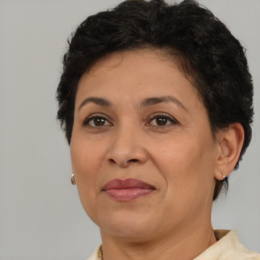 Joyful latino adult female with short  brown hair and brown eyes