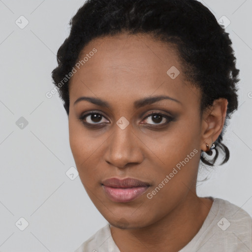 Joyful black young-adult female with short  black hair and brown eyes