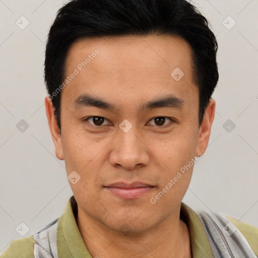 Joyful asian young-adult male with short  black hair and brown eyes