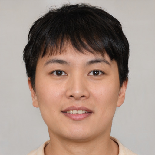 Joyful asian young-adult male with short  brown hair and brown eyes