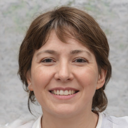 Joyful white adult female with medium  brown hair and grey eyes