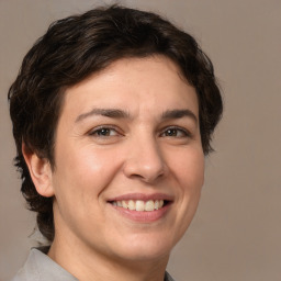 Joyful white adult female with medium  brown hair and brown eyes