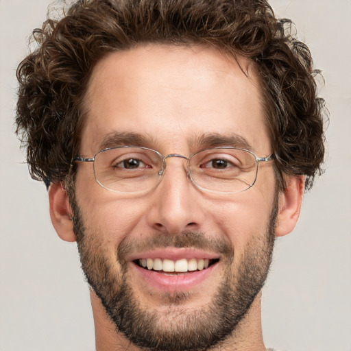 Joyful white adult male with short  brown hair and green eyes