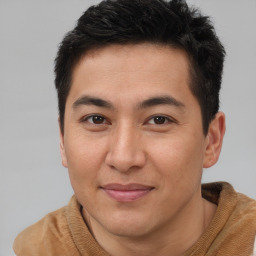 Joyful asian young-adult male with short  brown hair and brown eyes