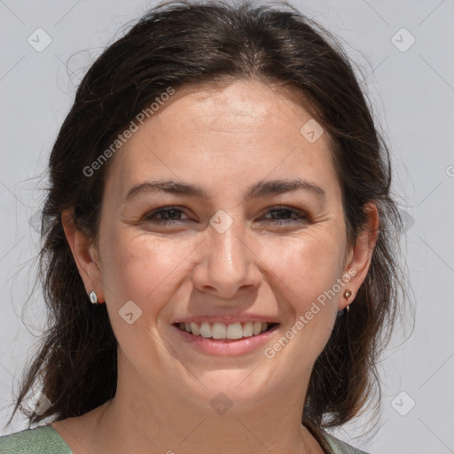 Joyful white adult female with medium  brown hair and brown eyes