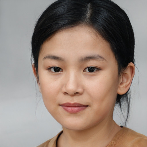 Joyful asian child female with medium  brown hair and brown eyes
