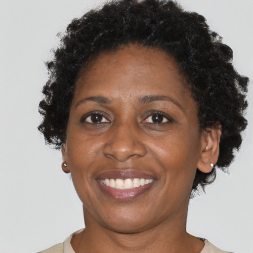 Joyful black adult female with short  brown hair and brown eyes