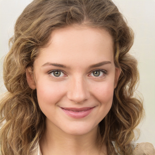 Joyful white young-adult female with medium  brown hair and green eyes