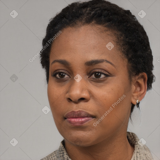 Joyful black young-adult female with short  black hair and brown eyes