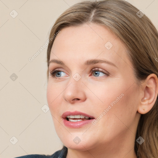 Joyful white young-adult female with long  brown hair and blue eyes