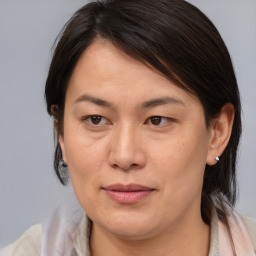 Joyful asian adult female with medium  brown hair and brown eyes