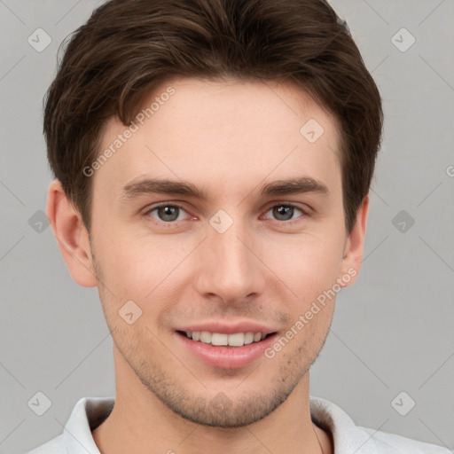 Joyful white young-adult male with short  brown hair and grey eyes