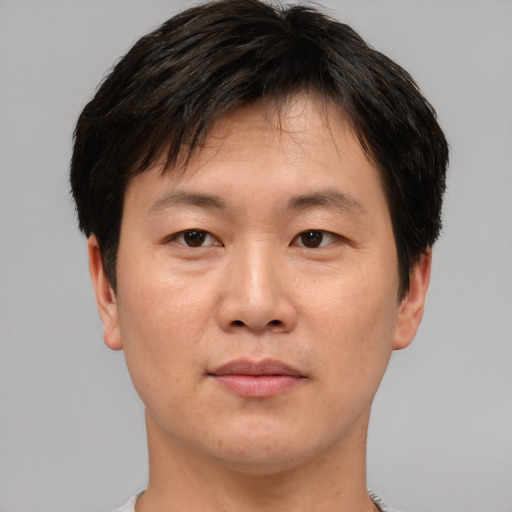 Neutral asian young-adult male with short  brown hair and brown eyes