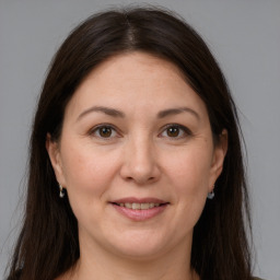 Joyful white adult female with long  brown hair and brown eyes