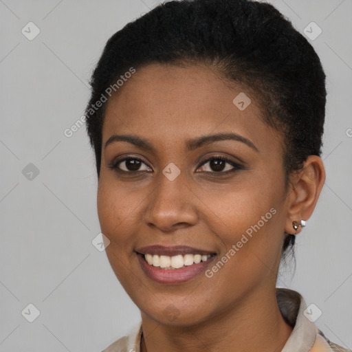 Joyful black young-adult female with short  brown hair and brown eyes