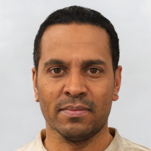 Neutral latino adult male with short  black hair and brown eyes