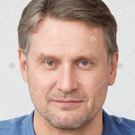 Joyful white adult male with short  brown hair and grey eyes