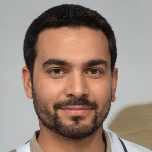 Joyful white young-adult male with short  black hair and brown eyes