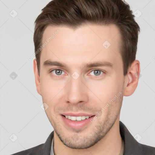 Joyful white young-adult male with short  brown hair and grey eyes