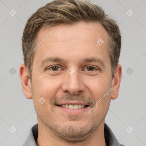 Joyful white adult male with short  brown hair and brown eyes