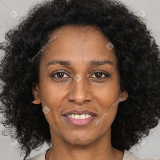 Joyful latino adult female with medium  brown hair and brown eyes