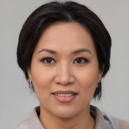 Joyful white adult female with medium  brown hair and brown eyes