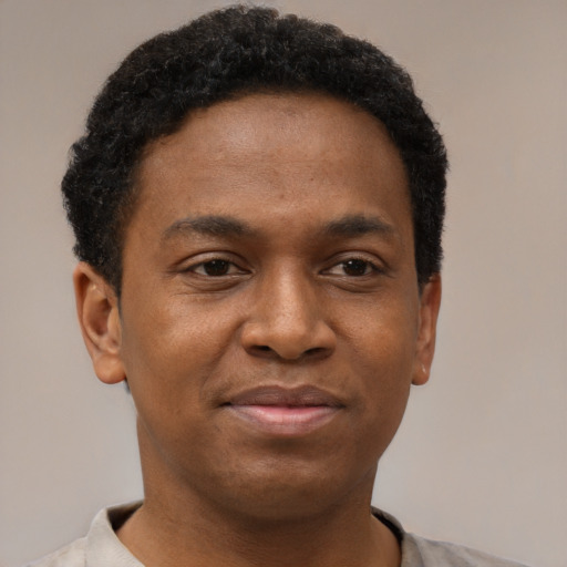 Joyful latino young-adult male with short  brown hair and brown eyes