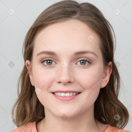 Joyful white young-adult female with medium  brown hair and blue eyes