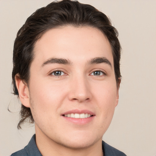 Joyful white young-adult male with medium  brown hair and brown eyes