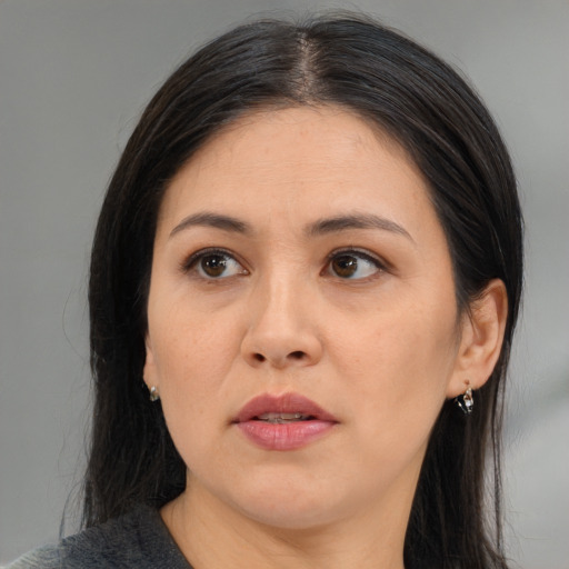 Neutral asian adult female with medium  brown hair and brown eyes