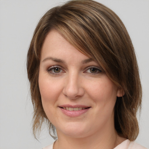 Joyful white young-adult female with medium  brown hair and grey eyes