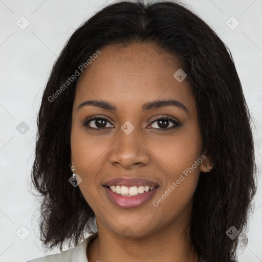 Joyful black young-adult female with long  brown hair and brown eyes