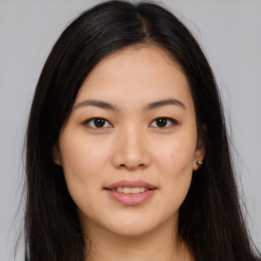 Joyful asian young-adult female with long  brown hair and brown eyes