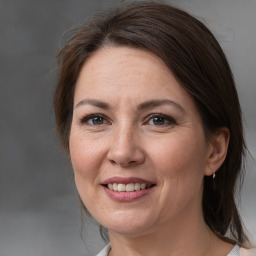 Joyful white adult female with medium  brown hair and brown eyes