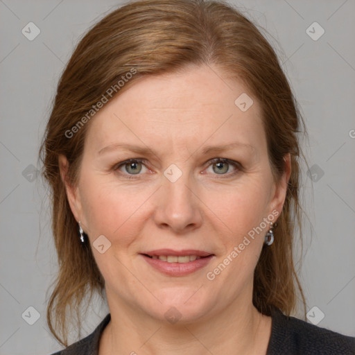 Joyful white adult female with medium  brown hair and grey eyes