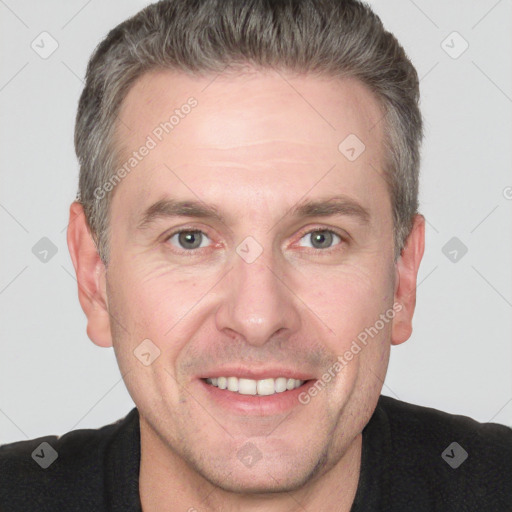 Joyful white adult male with short  brown hair and grey eyes