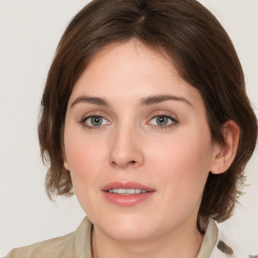 Joyful white young-adult female with medium  brown hair and blue eyes