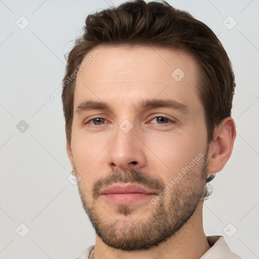 Joyful white young-adult male with short  brown hair and brown eyes