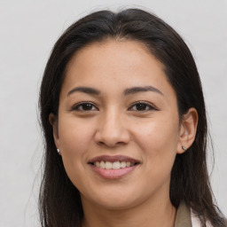 Joyful latino young-adult female with long  brown hair and brown eyes