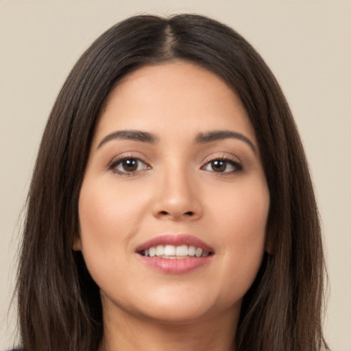 Joyful white young-adult female with long  brown hair and brown eyes