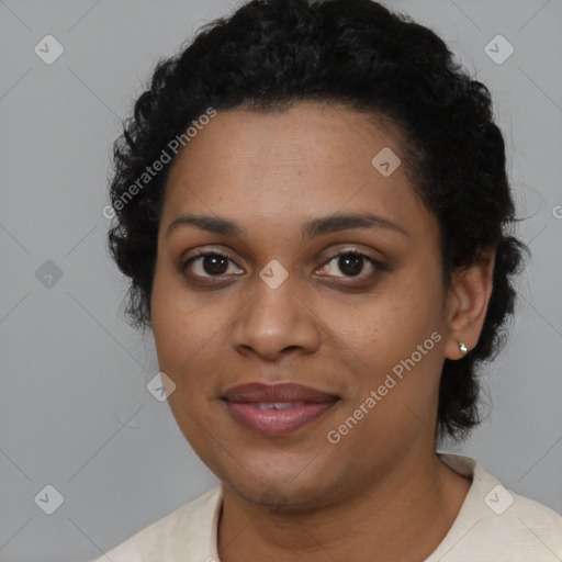 Joyful black young-adult female with short  black hair and brown eyes