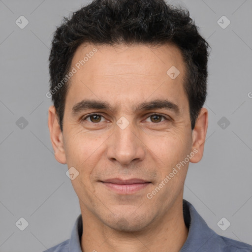 Joyful white adult male with short  black hair and brown eyes