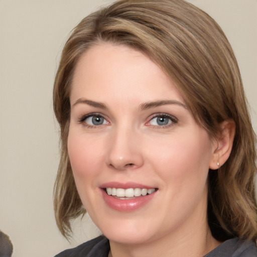 Joyful white young-adult female with medium  brown hair and blue eyes