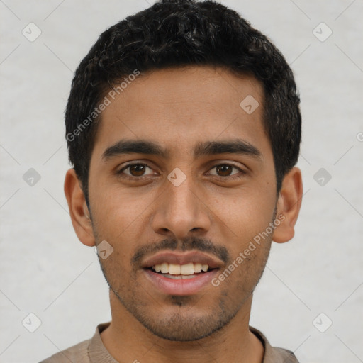 Joyful latino young-adult male with short  black hair and brown eyes