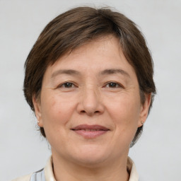 Joyful white adult female with medium  brown hair and brown eyes