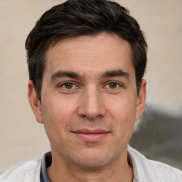 Joyful white adult male with short  brown hair and brown eyes