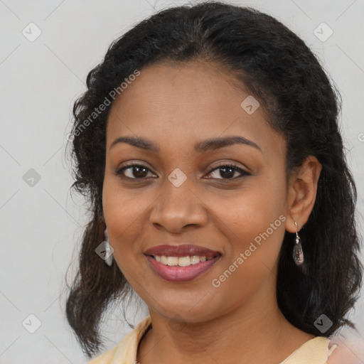 Joyful black young-adult female with long  brown hair and brown eyes