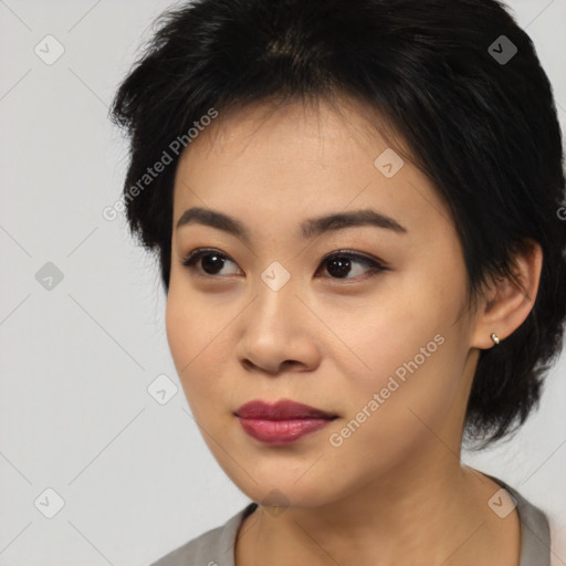 Joyful asian young-adult female with medium  black hair and brown eyes